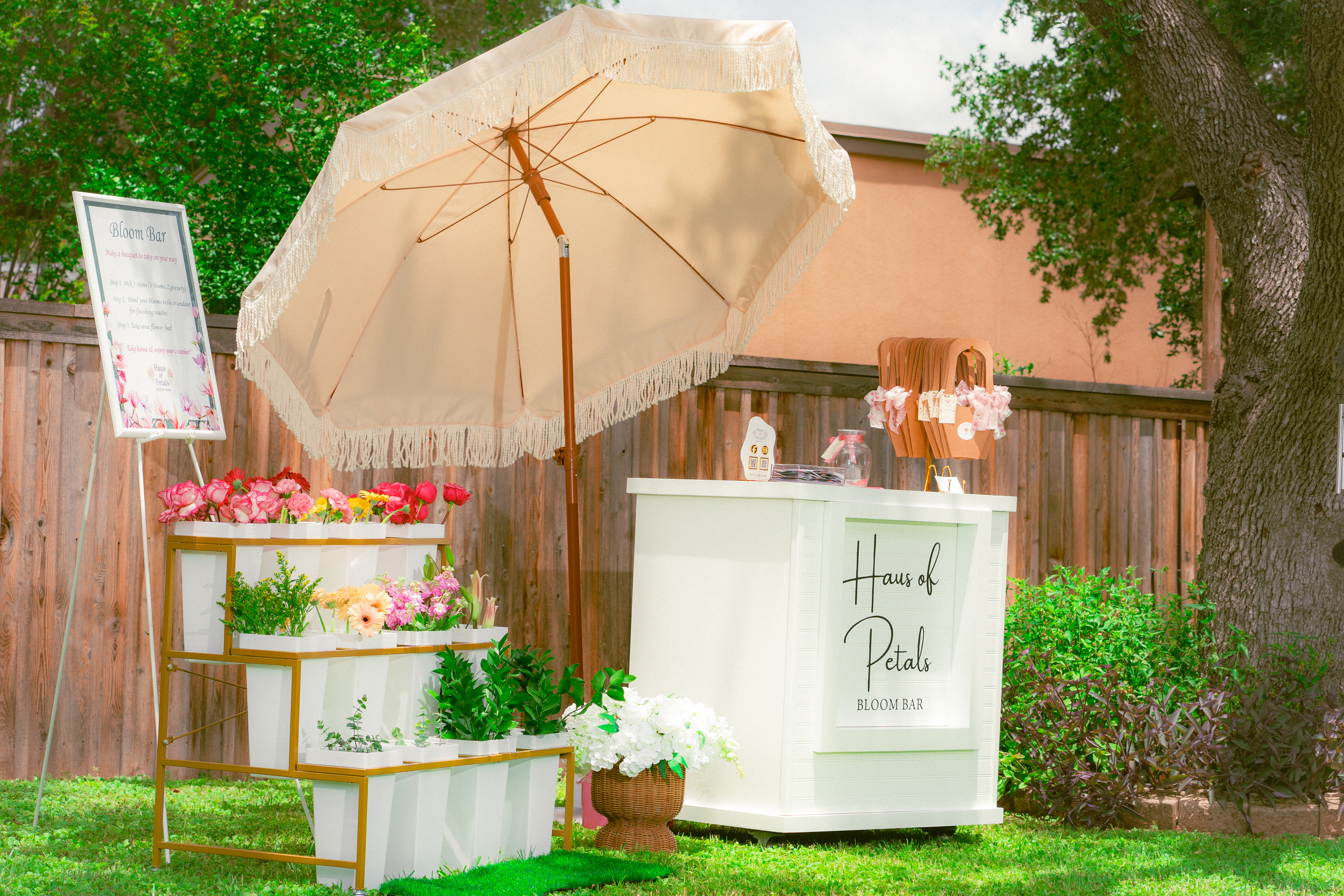 Haus of Petals bloom bar cart with fringed umbrella set up outdoors, Austin TX