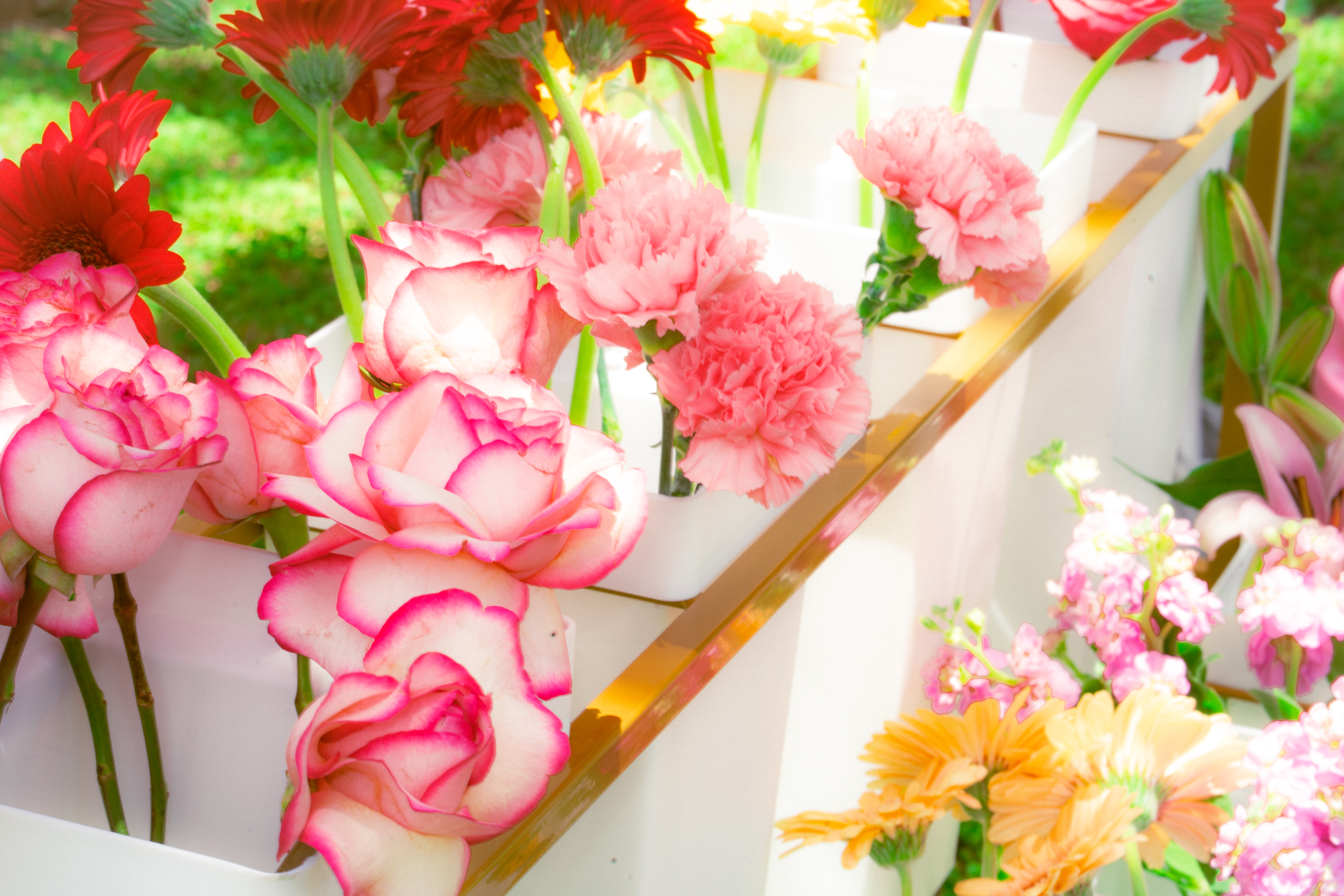 Close-up of pink garden roses and carnations in white buckets, Haus of Petals