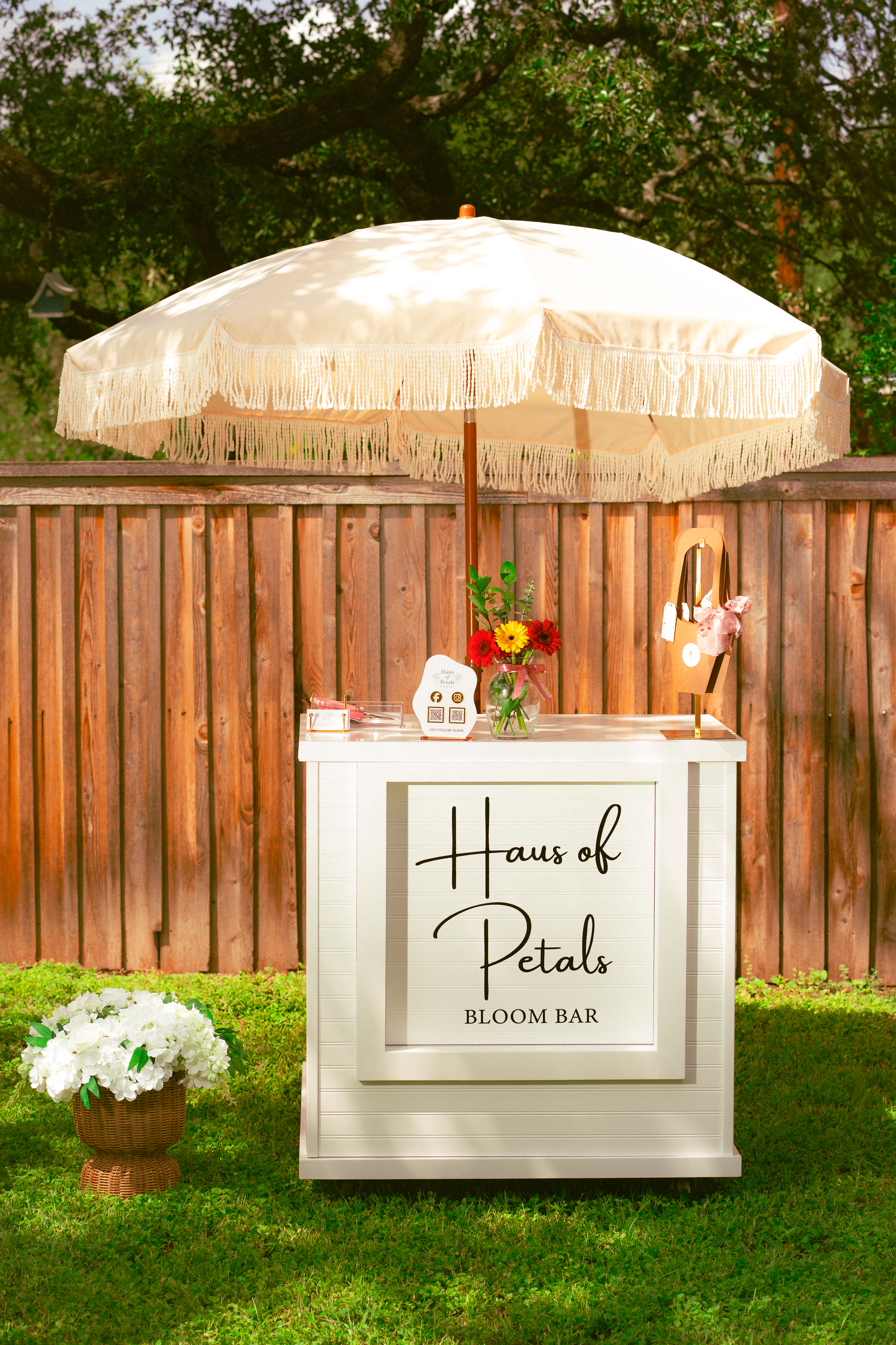 Full Haus of Petals bloom bar styling with umbrella and flower stand, Austin TX