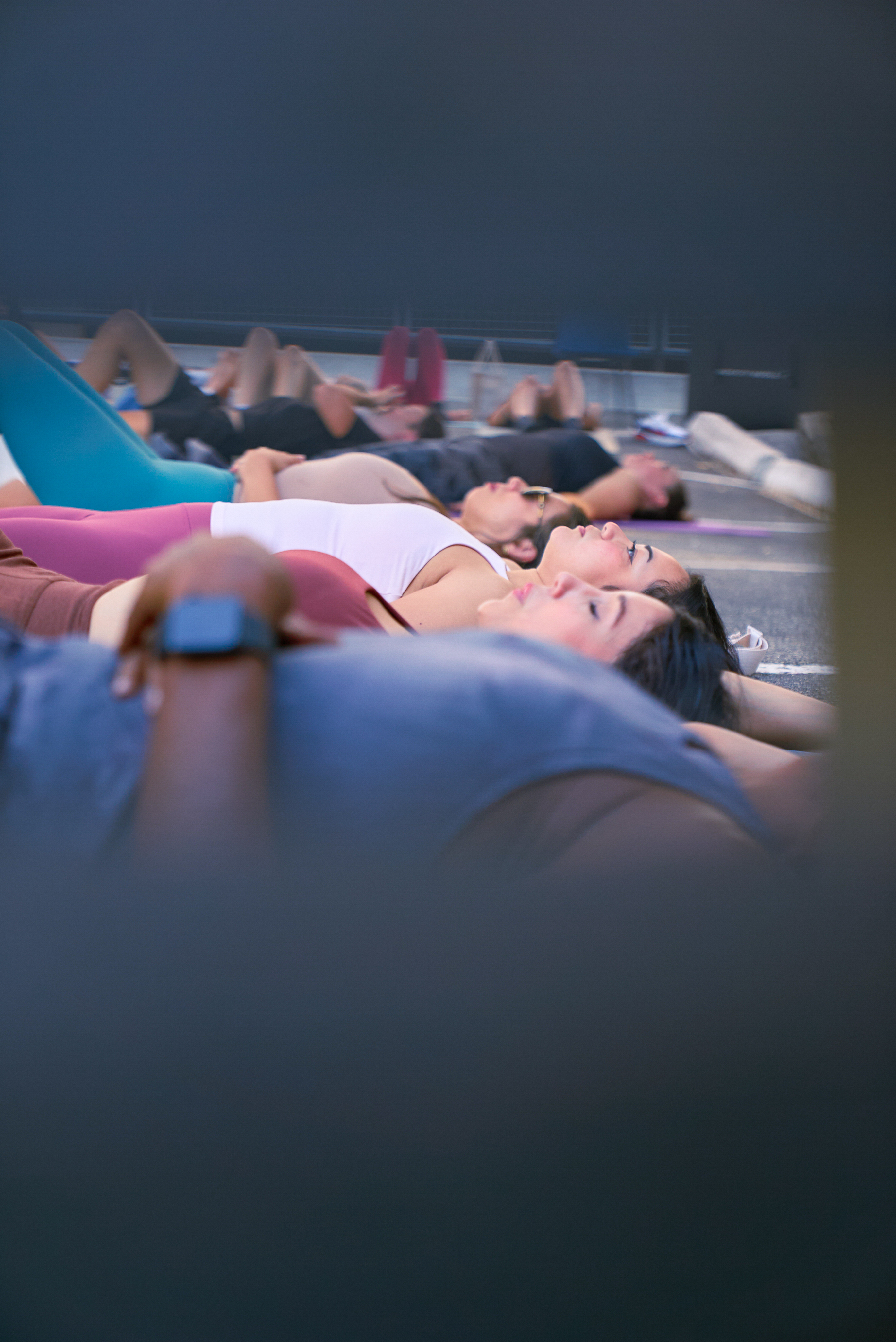 Group lying in savasana during a recovery session at the Native Roots event