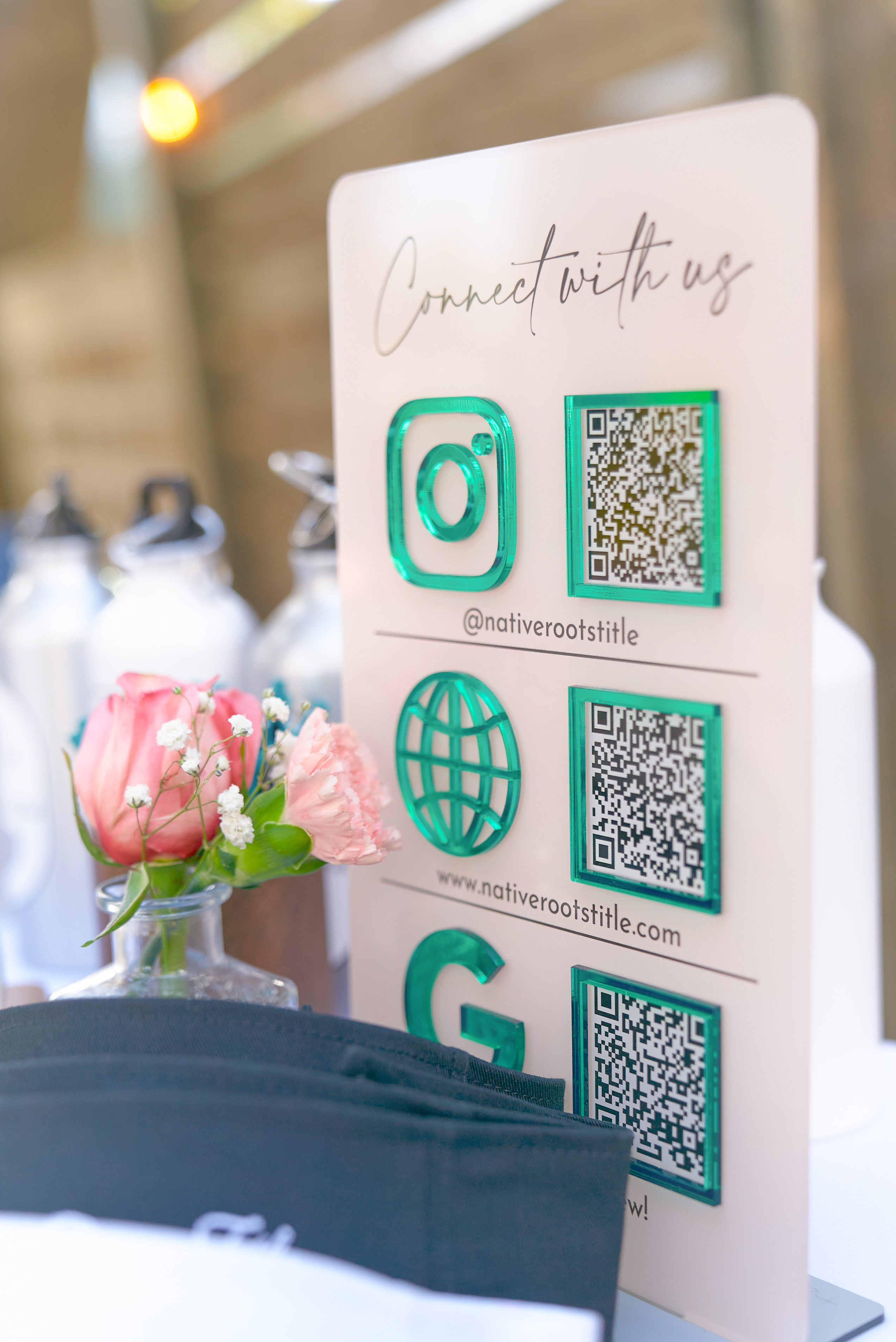 Connect-with-us QR code sign with green acrylic icons at the Native Roots Title event