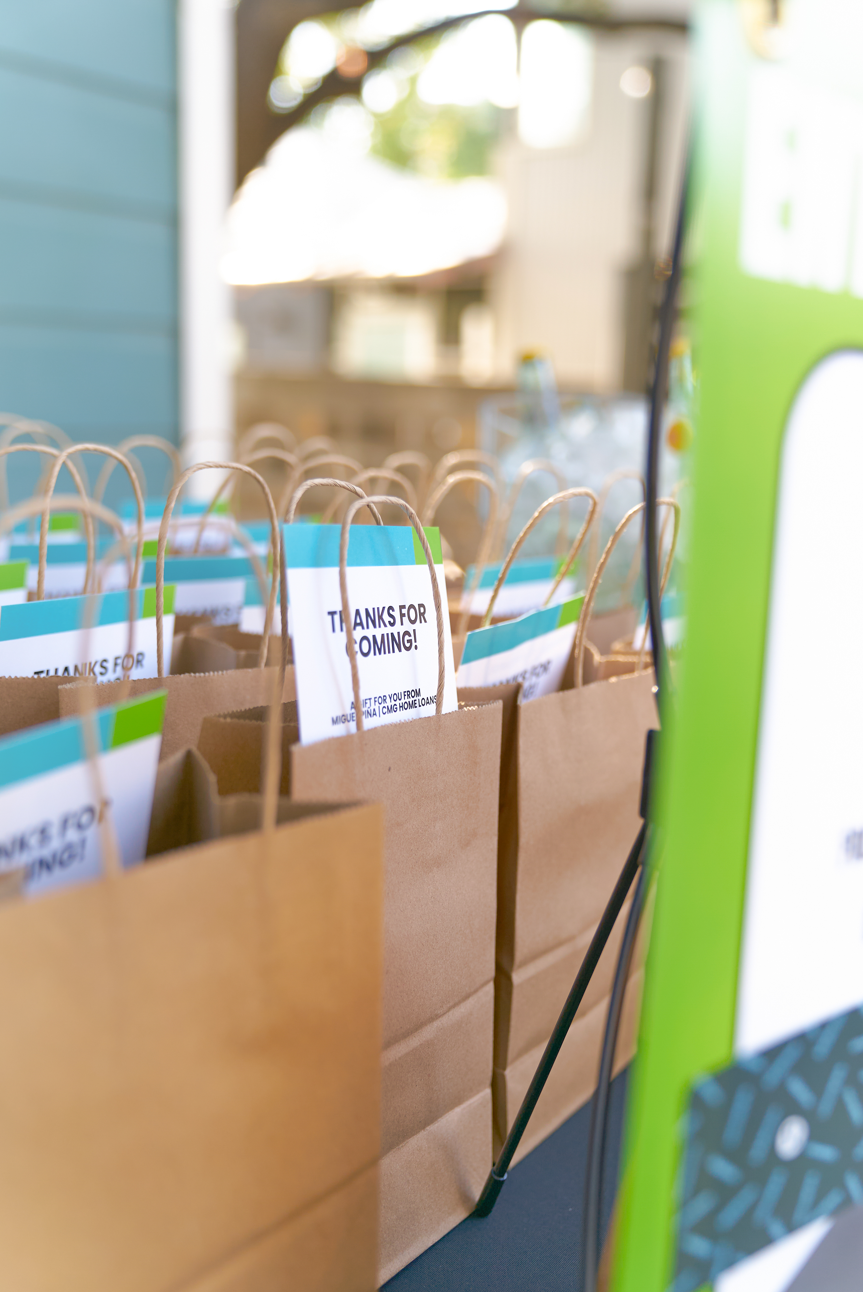 Kraft gift bags with thank-you cards lined up at the Native Roots event, Austin TX