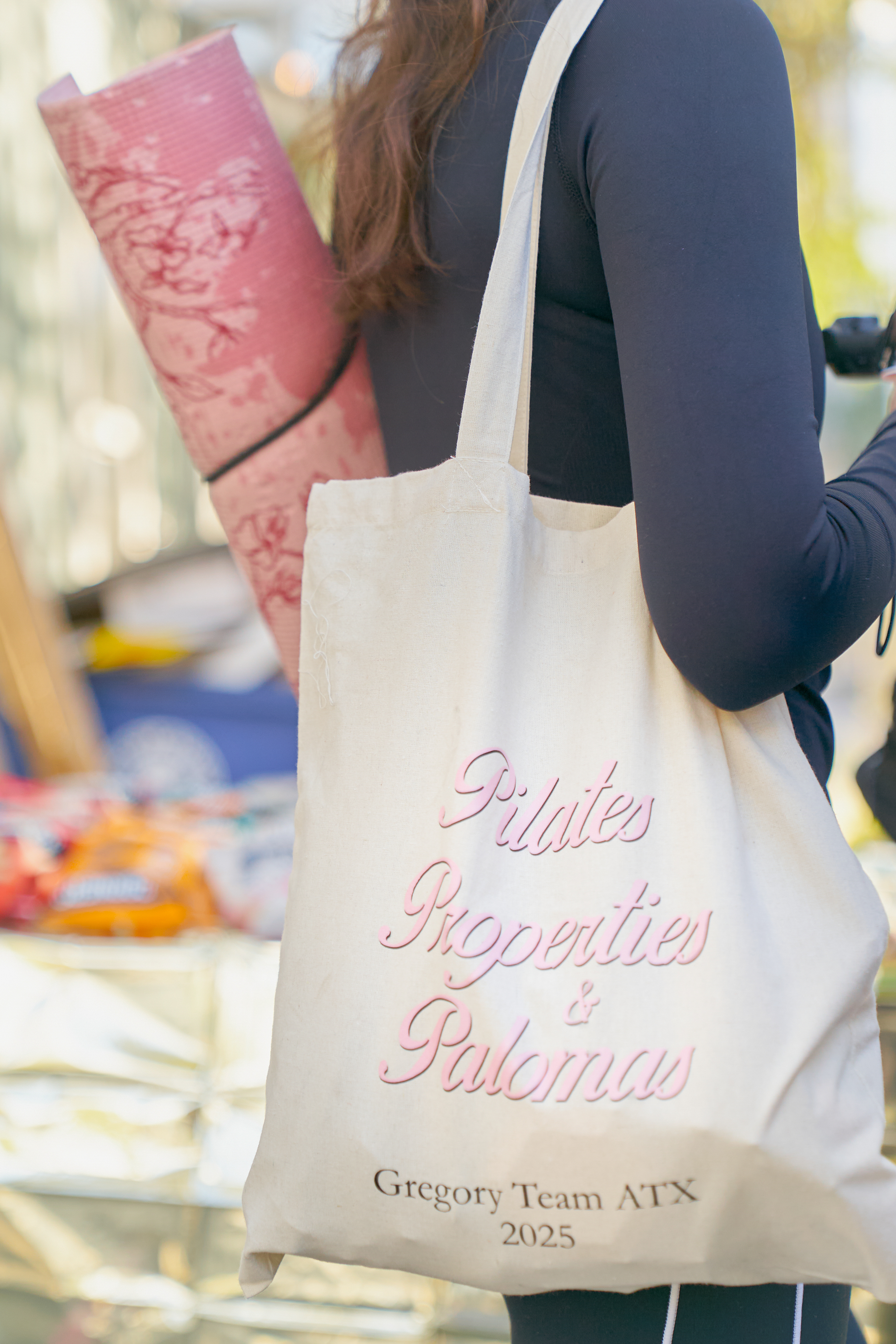Pilates, Properties and Palomas tote bag with a rolled pink yoga mat, Native Roots event